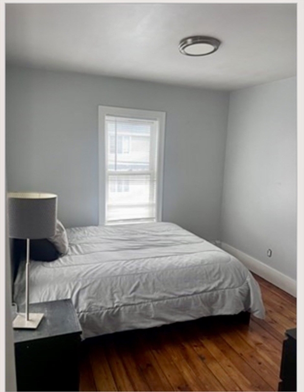 18 West Street, Unit A Everett, MA 02149 - Photo 8 of 10 a bedroom with a bed and a window