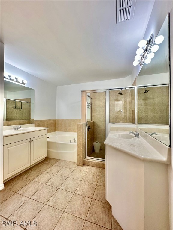 10210 Tin Maple Drive, Unit 135 Estero, FL 33928 - Photo 15 of 19 a large bathroom with a granite countertop sink a large mirror and a bathtub