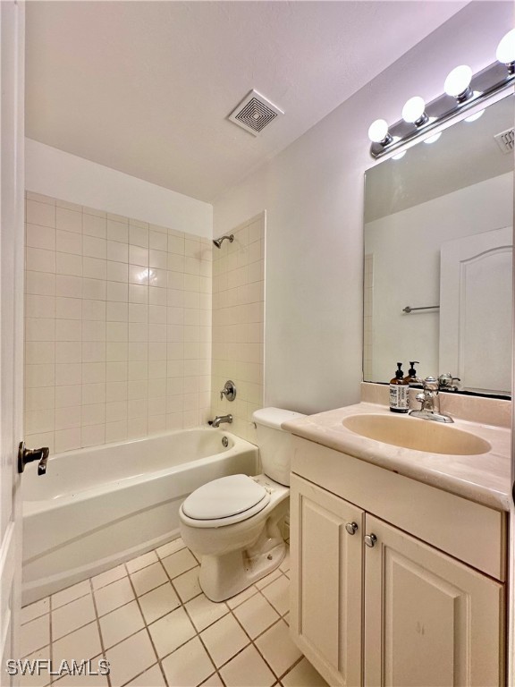 10210 Tin Maple Drive, Unit 135 Estero, FL 33928 - Photo 17 of 19 a bathroom with a sink a toilet a mirror a bathtub and shower
