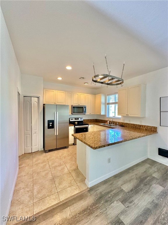 10210 Tin Maple Drive, Unit 135 Estero, FL 33928 - Photo 8 of 19 a large kitchen with granite countertop a stove and a sink