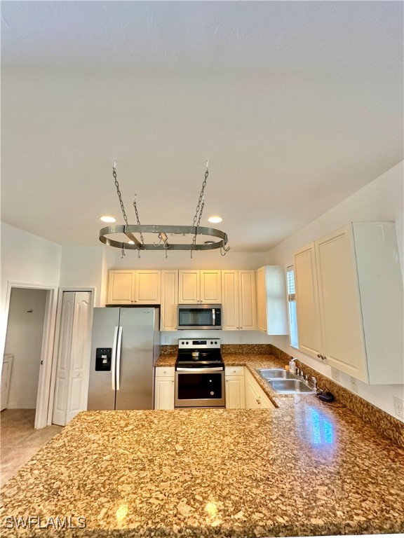 10210 Tin Maple Drive, Unit 135 Estero, FL 33928 - Photo 9 of 19 a large kitchen with a stove a refrigerator and a sink