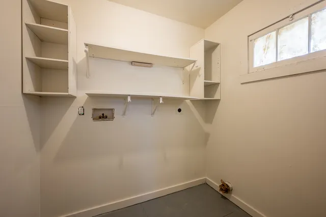 a view of storage and utility room with closet