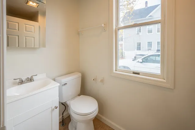 a white toilet sitting next to a bathroom sink