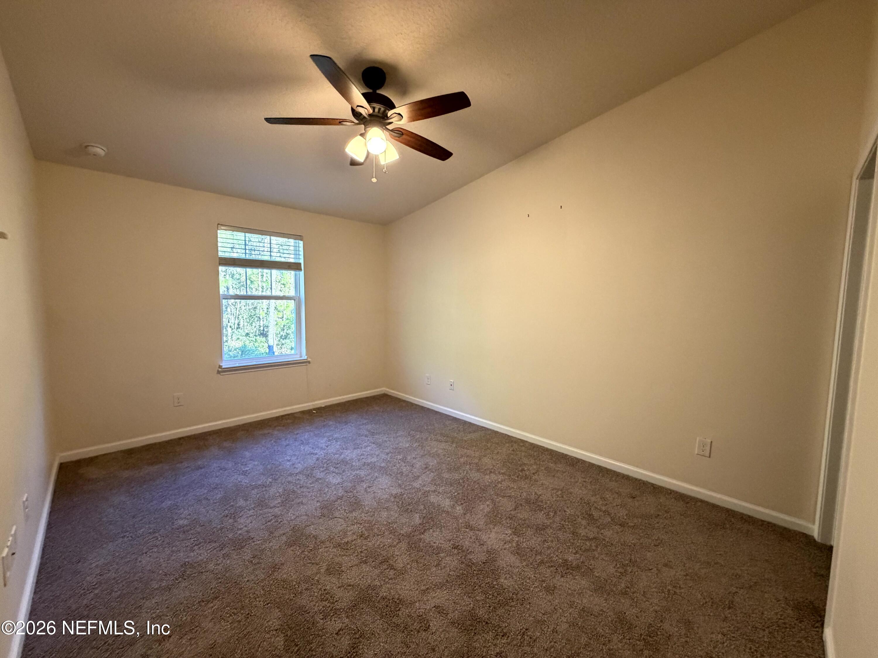 1717 Golden Lake Loop St. Augustine, FL 32084 - Photo 10 of 24 an empty room with windows and fan