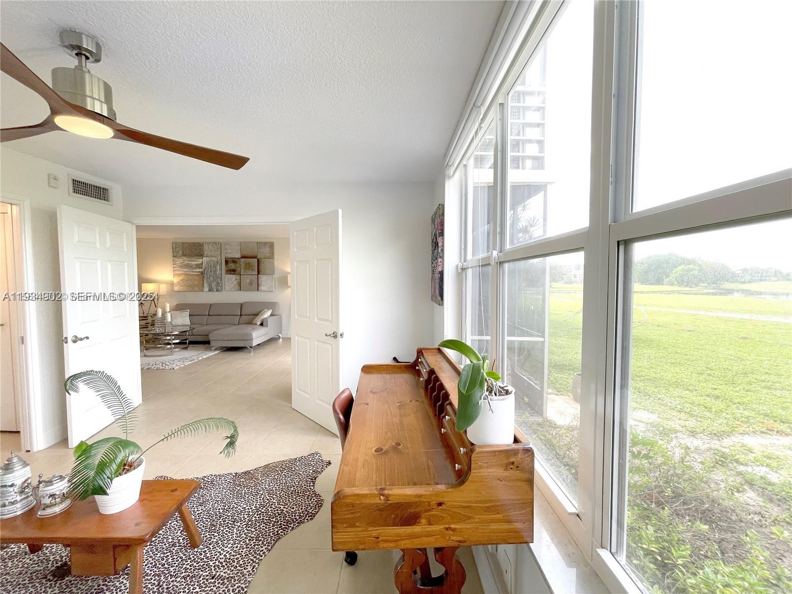 2671 South Course Drive, Unit 109 Pompano Beach, FL 33069 - Photo 19 of 39 a living room with furniture and a large window