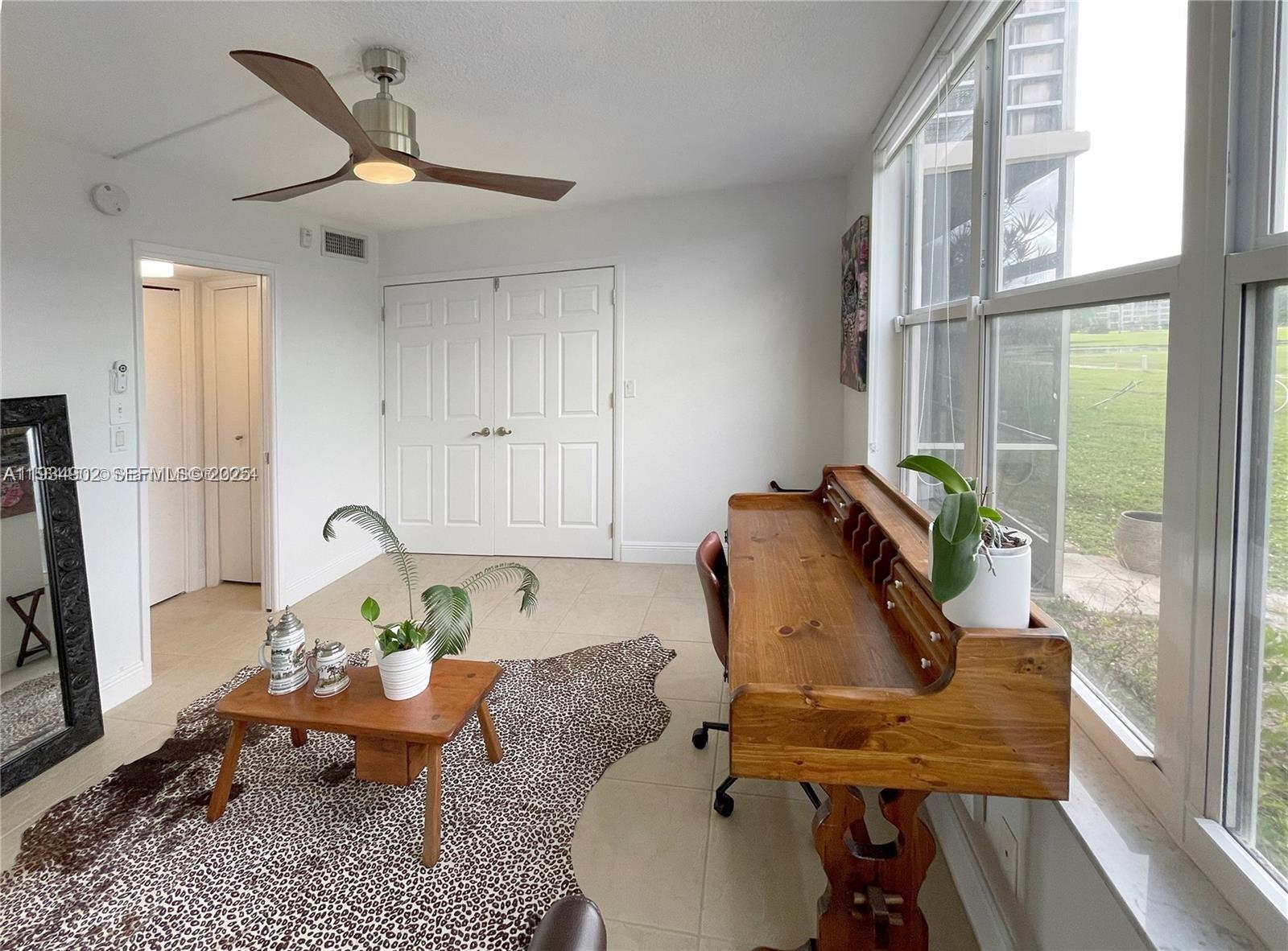 2671 South Course Drive, Unit 109 Pompano Beach, FL 33069 - Photo 20 of 39 a living room with furniture and a window