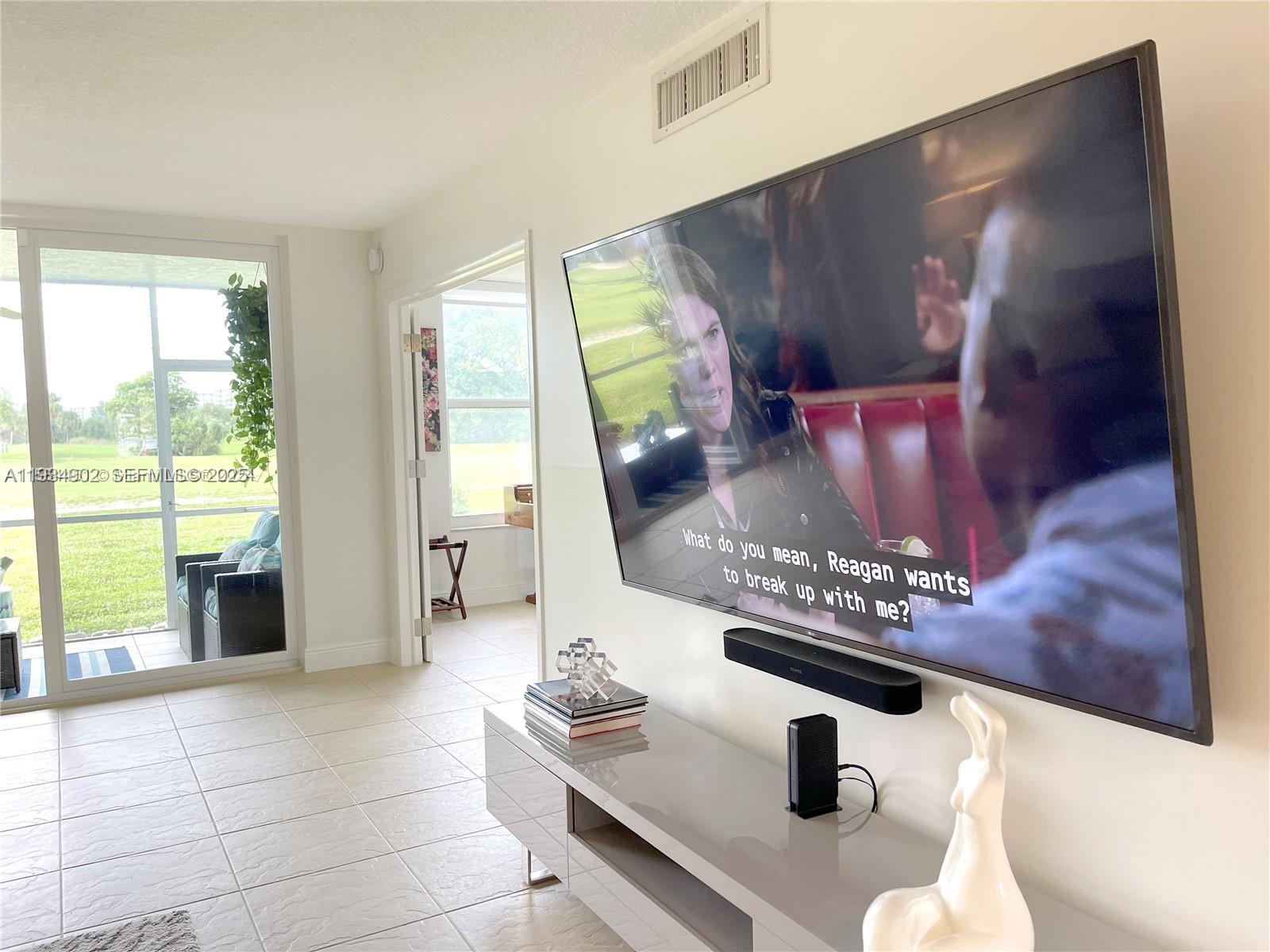 2671 South Course Drive, Unit 109 Pompano Beach, FL 33069 - Photo 2 of 39 a living room with furniture and a fireplace