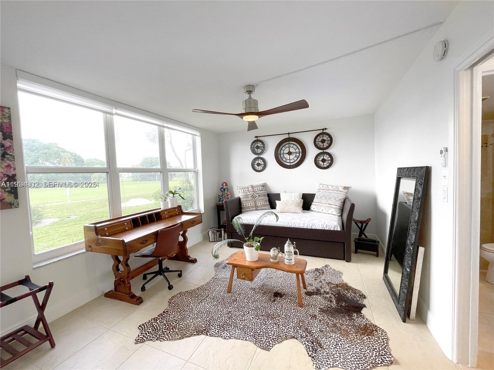 2671 South Course Drive, Unit 109 Pompano Beach, FL 33069 - Photo 22 of 39 a bedroom with furniture and a window