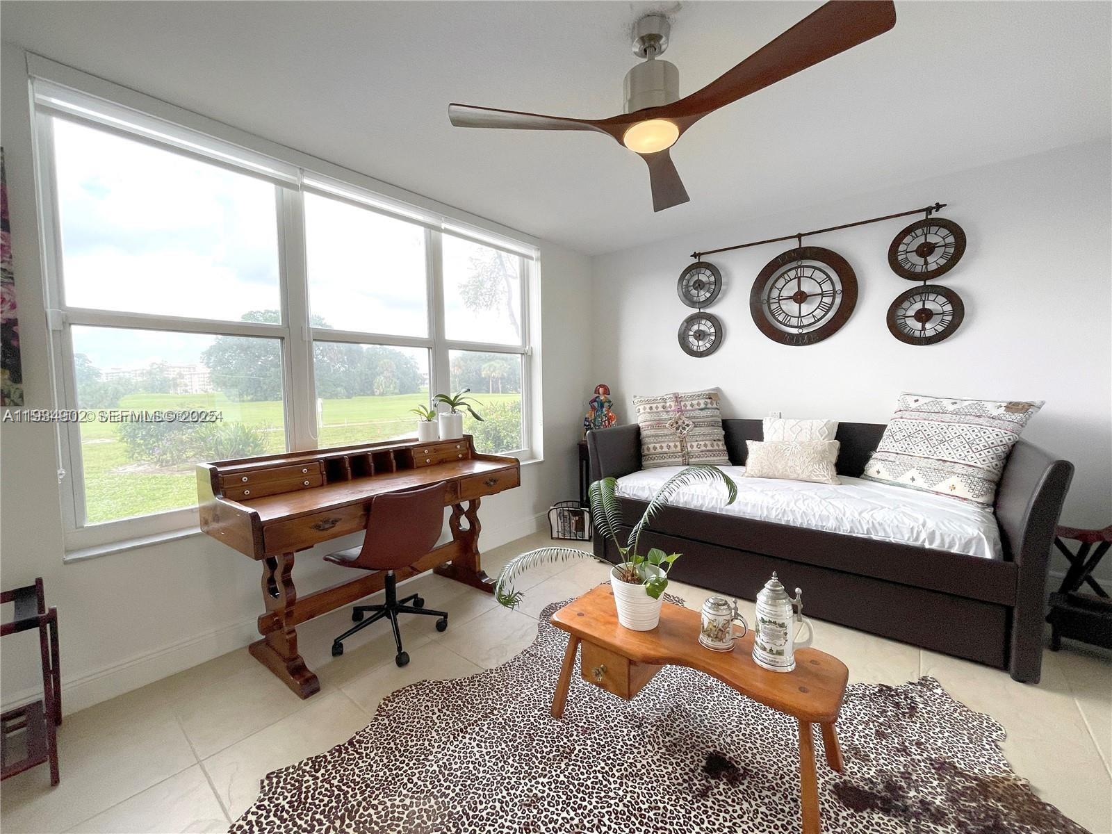 2671 South Course Drive, Unit 109 Pompano Beach, FL 33069 - Photo 25 of 39 a living room with furniture and a large window