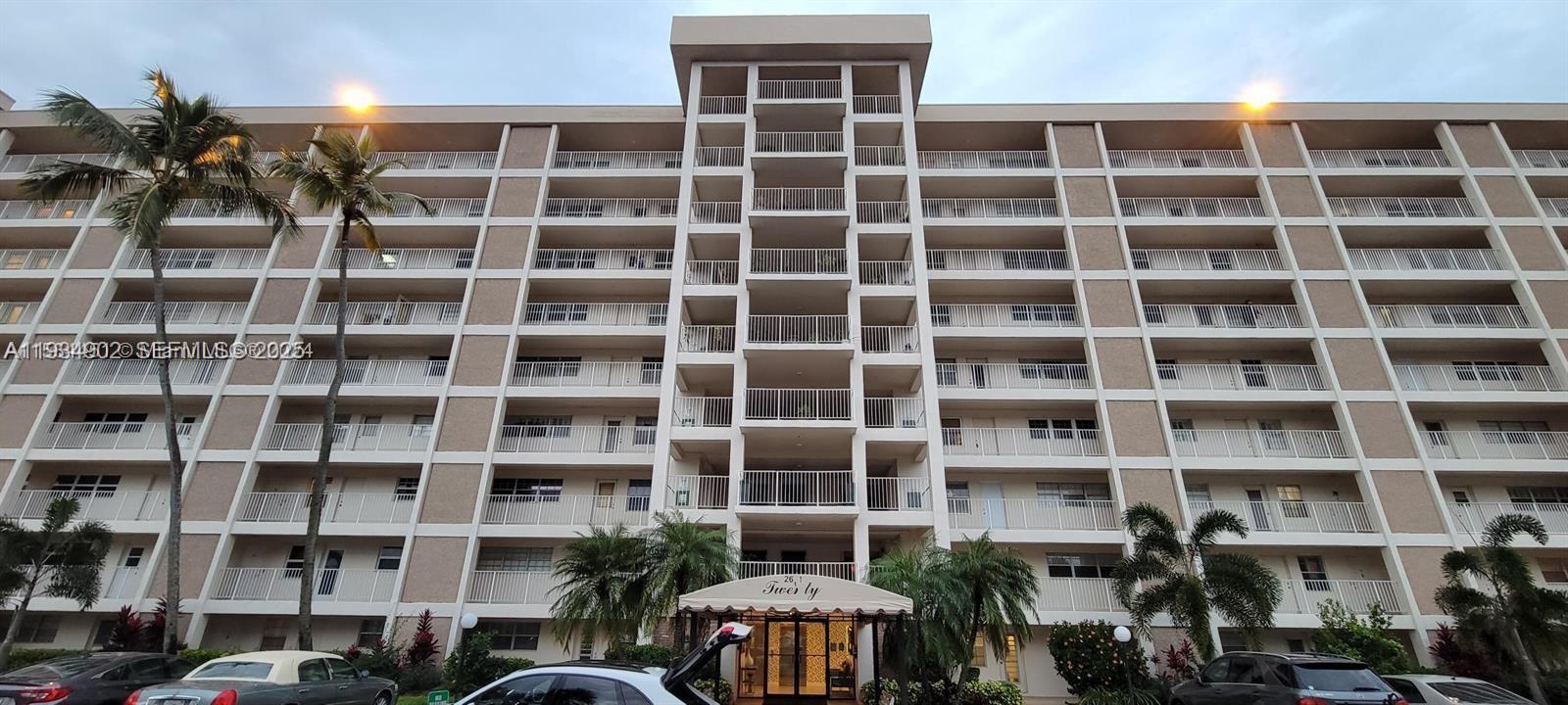 2671 South Course Drive, Unit 109 Pompano Beach, FL 33069 - Photo 28 of 39 a front view of a building with a lot of windows