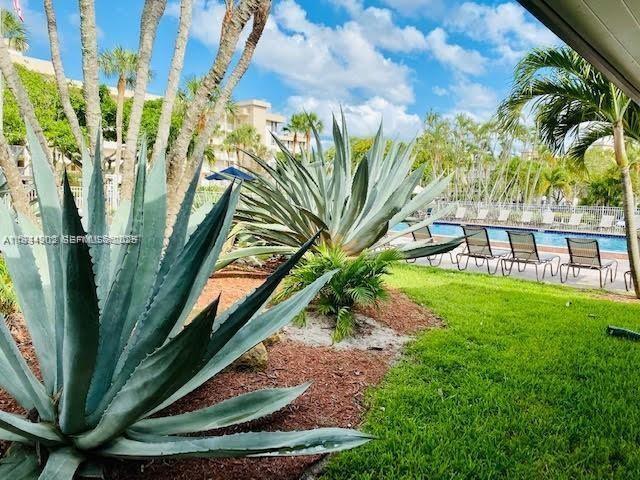 2671 South Course Drive, Unit 109 Pompano Beach, FL 33069 - Photo 29 of 39 a view of a backyard with a garden