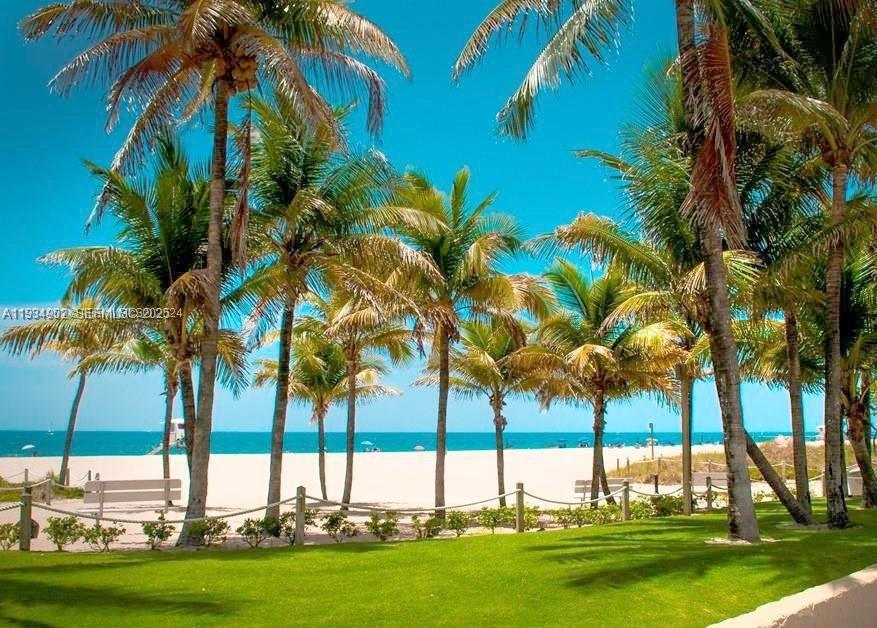 2671 South Course Drive, Unit 109 Pompano Beach, FL 33069 - Photo 32 of 39 a view of three palm trees