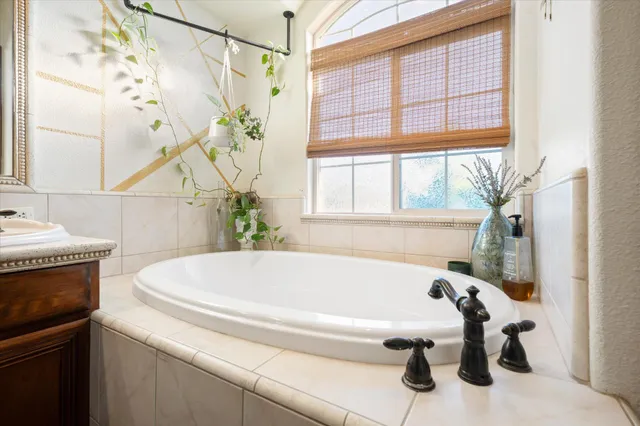 a bedroom with a bed couch and a window