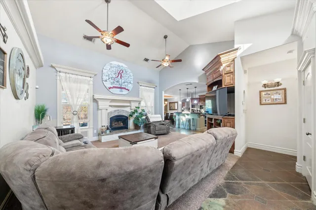 a living room with furniture a fireplace and a chandelier