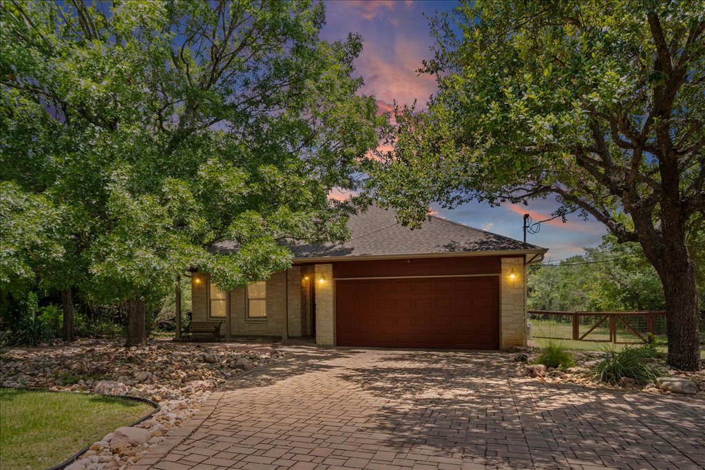 37 Pillow Road Austin, TX 78745 - Photo 1 of 18 A charming stone facade with a rich wood garage door creates inviting curb appeal.