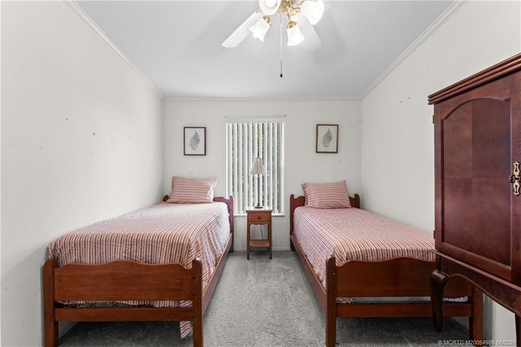4237 4th Court Lantana, FL 33462 - Photo 26 of 40 a bedroom with two beds and a chandelier