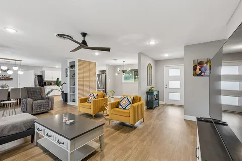 a living room with furniture and wooden floor