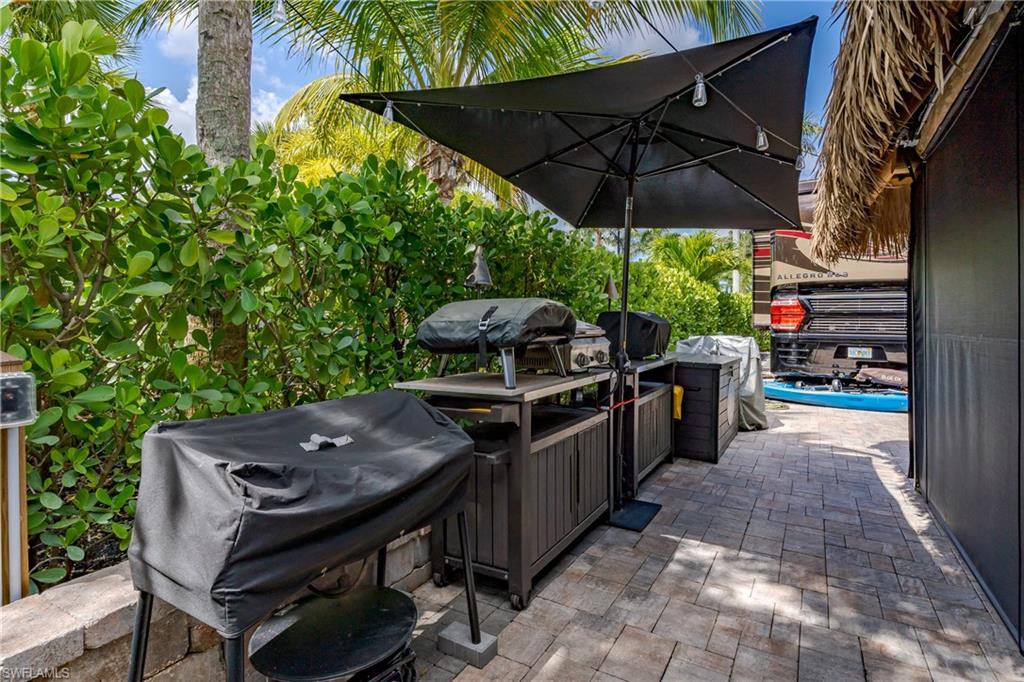 13571 Snook Circle Naples, FL 34114 - Photo 12 of 47 a view of a chairs and table in the patio