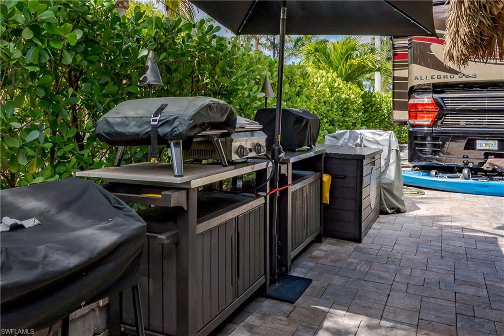 13571 Snook Circle Naples, FL 34114 - Photo 13 of 47 a view of an outdoor sitting area with brick walls