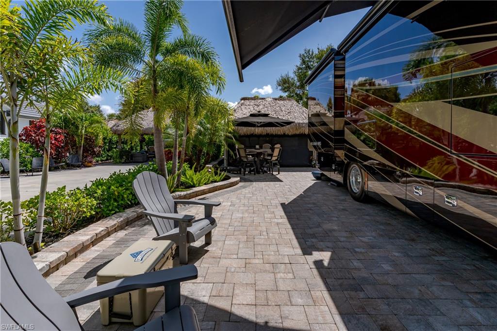 13571 Snook Circle Naples, FL 34114 - Photo 20 of 47 a view of a backyard with furniture and a grill