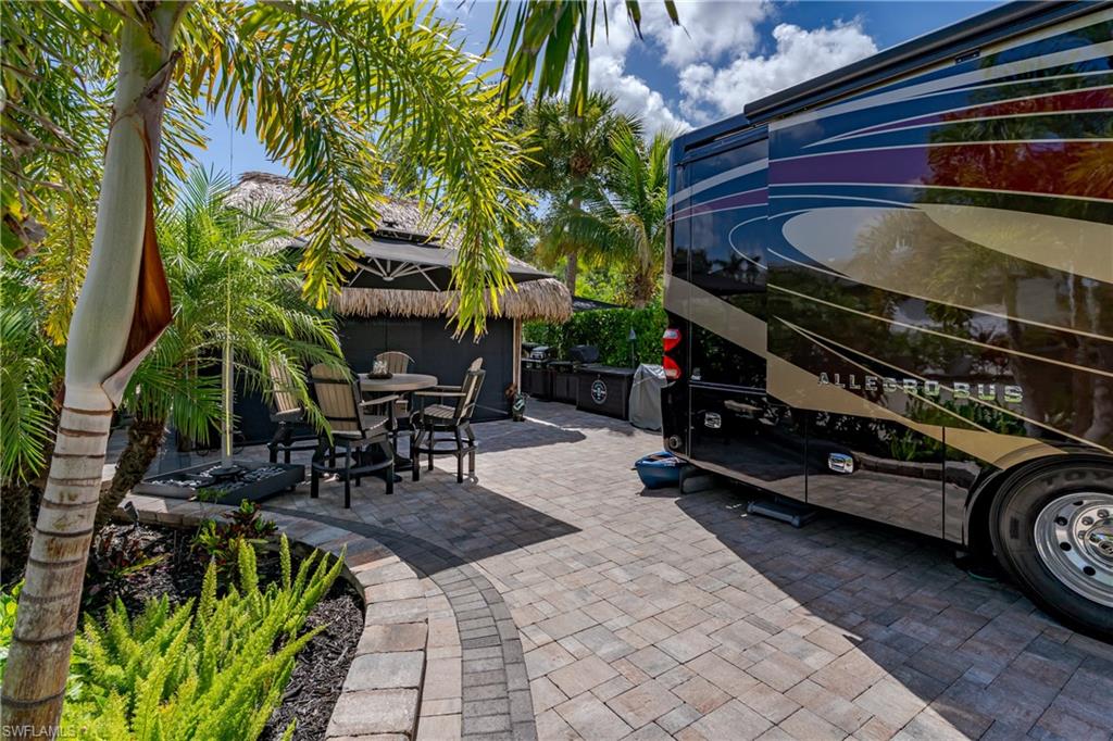13571 Snook Circle Naples, FL 34114 - Photo 26 of 47 a view of a chairs and table in a patio