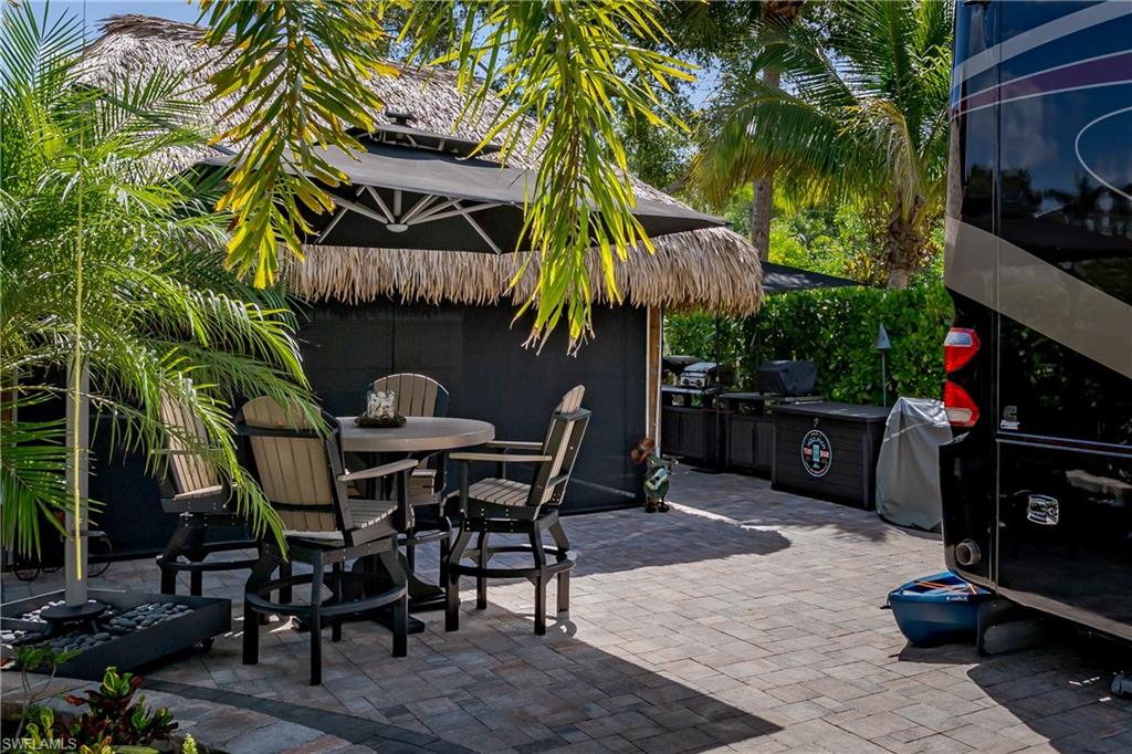 13571 Snook Circle Naples, FL 34114 - Photo 28 of 47 a view of a tables and chairs in patio