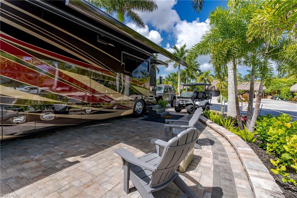 13571 Snook Circle Naples, FL 34114 - Photo 29 of 47 a view of a patio with table and chairs and potted plants