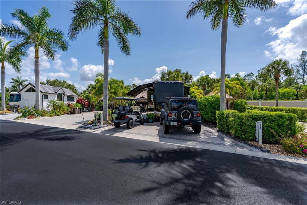 13571 Snook Circle Naples, FL 34114 - Photo 41 of 47 a view of a swimming pool with a table and chairs