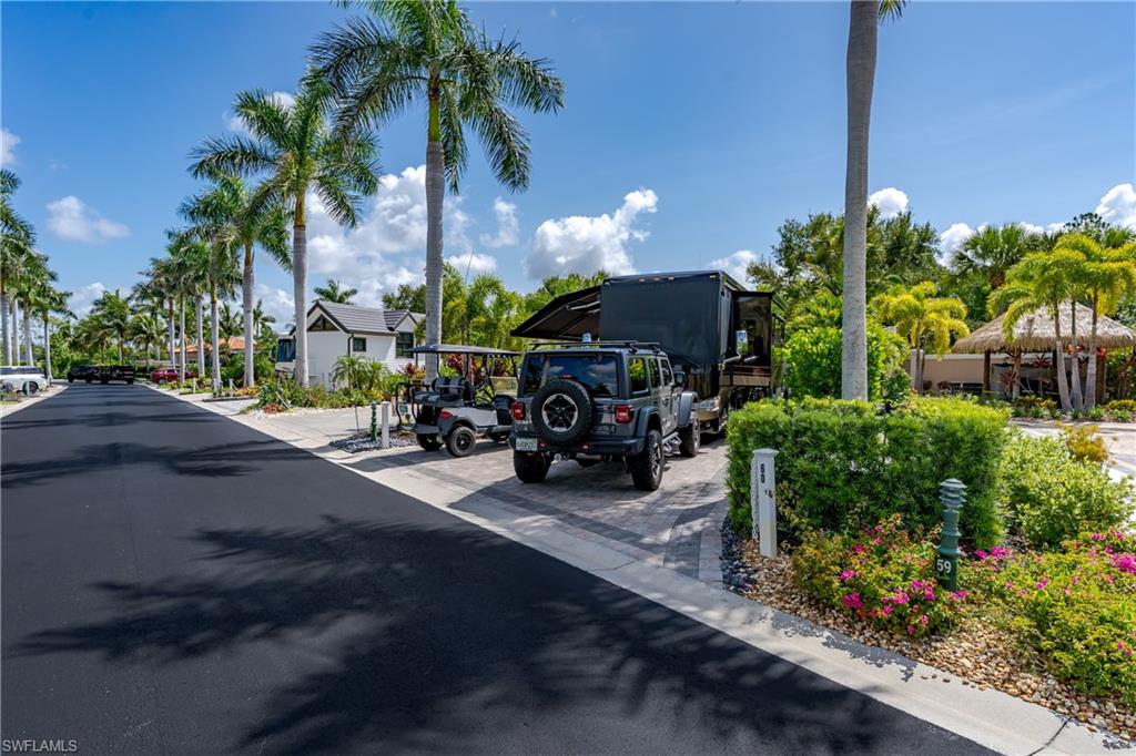 13571 Snook Circle Naples, FL 34114 - Photo 42 of 47 a front view of a house with garden