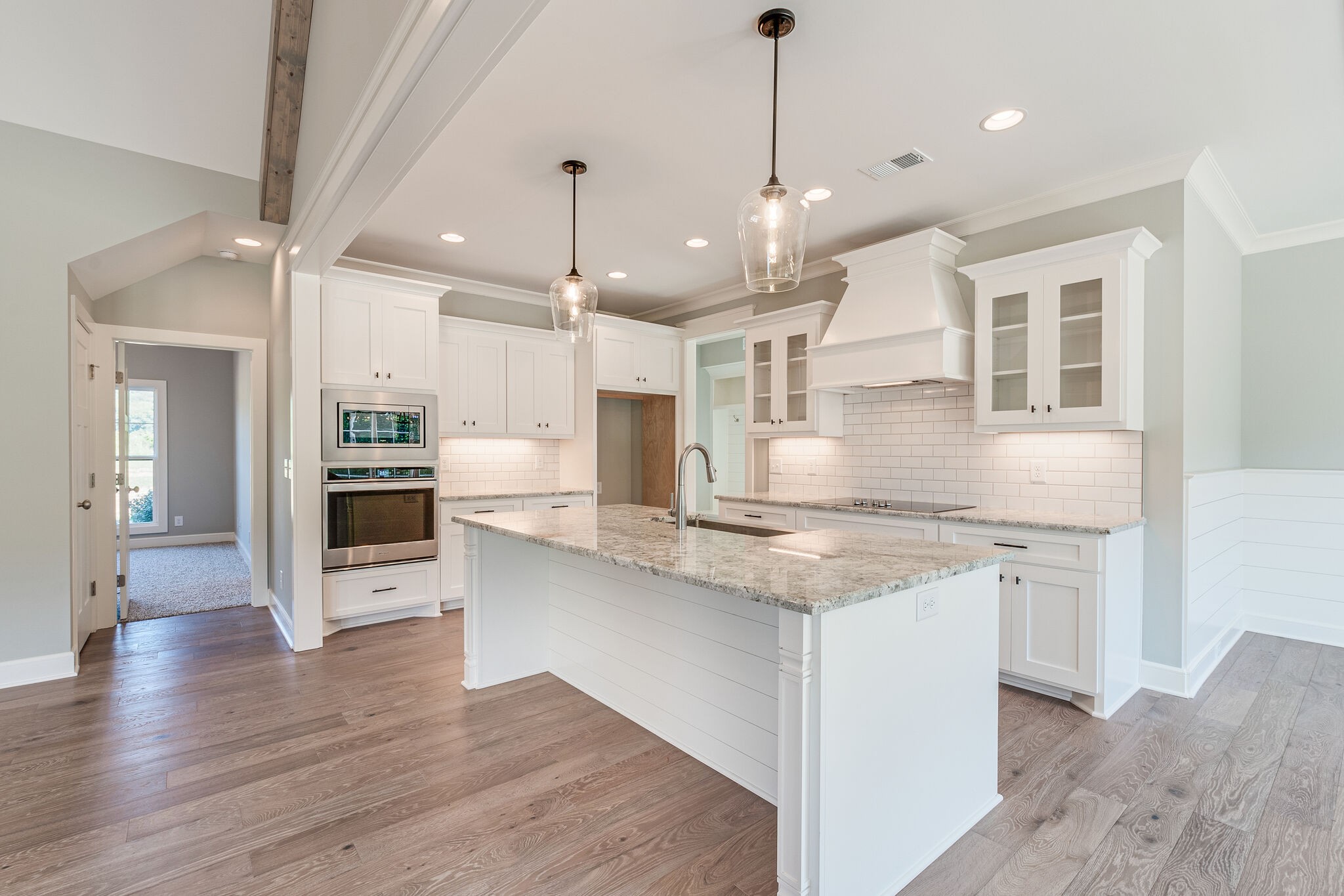 12425 North Milton Road Milton, TN 37118 - Photo 12 of 34 a large kitchen with stainless steel appliances kitchen island a large island in the center and wooden floors
