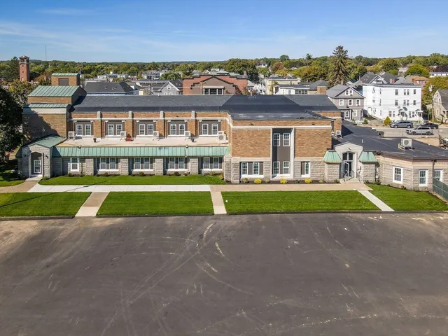 a view of a big room with a big yard and large trees