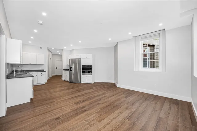 a view of kitchen with stainless steel appliances refrigerator microwave and stove