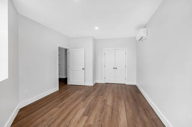 a view of a room with wooden floor