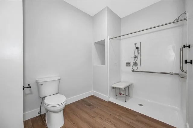 a bathroom with a toilet and a shower