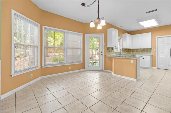 a kitchen with kitchen island granite countertop appliances cabinets and a counter top space