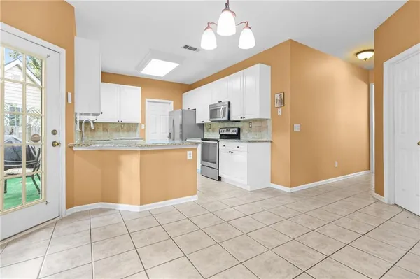 a view of livingroom with kitchen view and a window