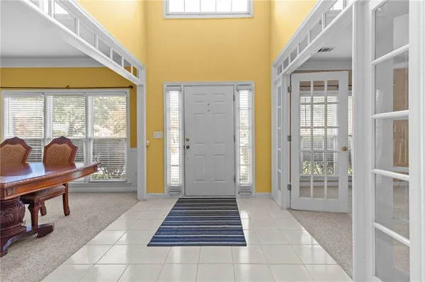 a lobby with furniture and floor to ceiling window