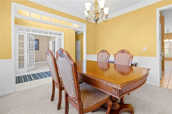 a view of a dining room with furniture and a chandelier