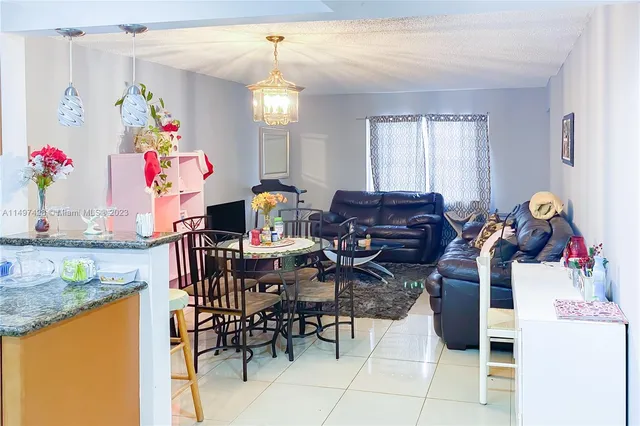 a view of a dining room with furniture and a chandelier
