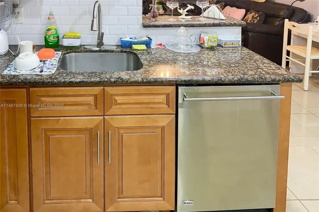 a kitchen with sink and refrigerator