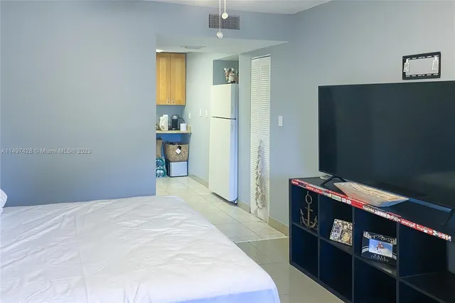 a bedroom with a bed and a wooden floor