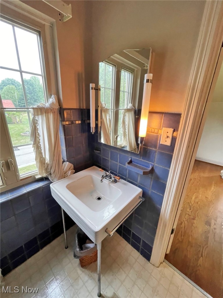 2702 Martin Road Zanesville, OH 43701 - Photo 29 of 34 Bathroom with tile walls and a healthy amount of sunlight