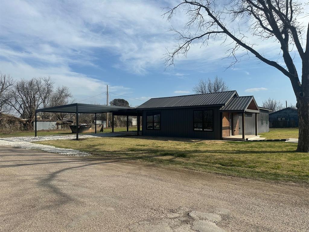 501 Rose Street Merkel, TX 79536 - Photo 2 of 13 a view of a big house with a big yard and large tree