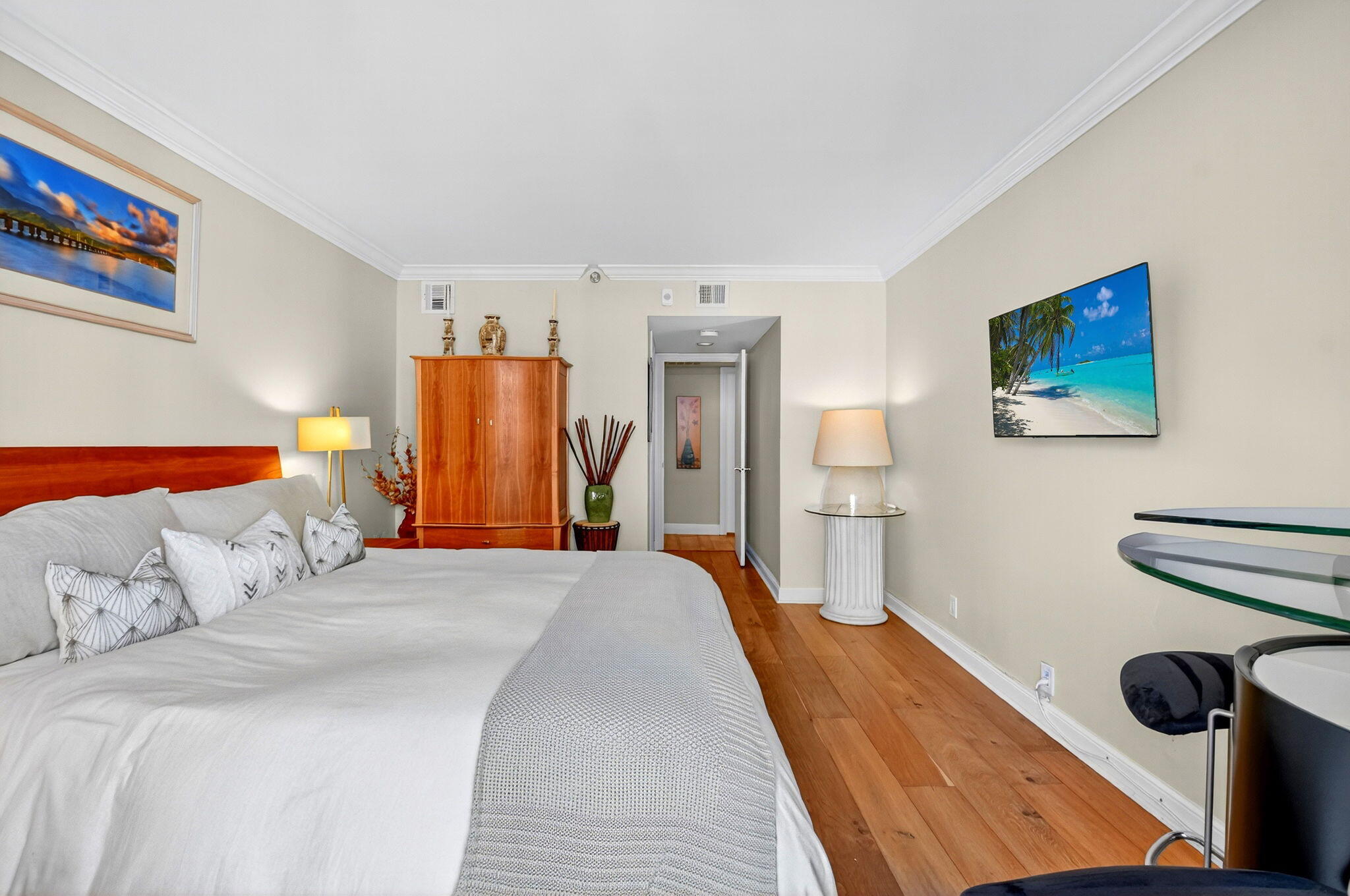 3390 South Ocean Boulevard, Unit 305 Palm Beach, FL 33480 - Photo 16 of 48 a bedroom with a bed and a painting on the wall