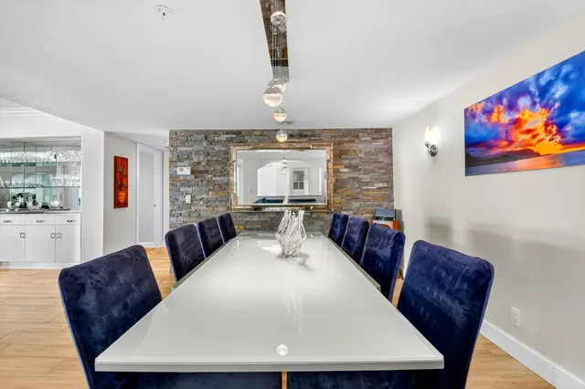 a living room with furniture flowerpot and wooden floor