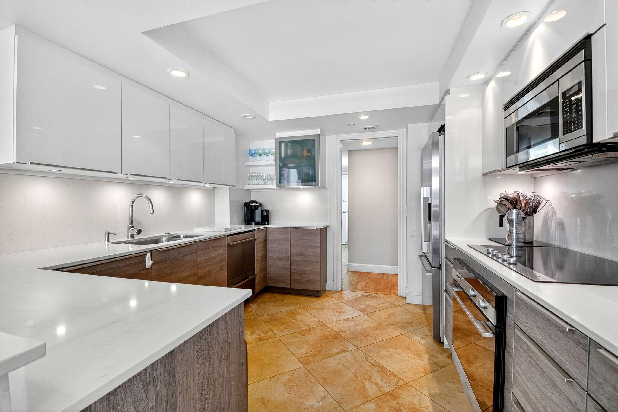 3390 South Ocean Boulevard, Unit 305 Palm Beach, FL 33480 - Photo 9 of 48 a kitchen with stainless steel appliances granite countertop a sink and a stove