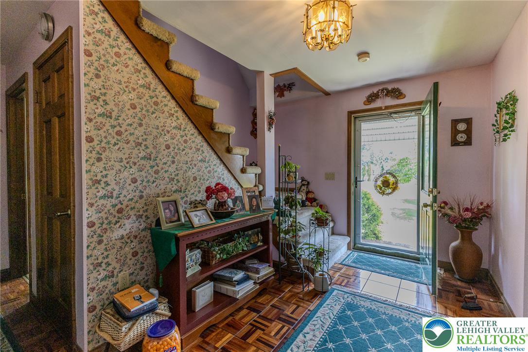 40 Locke Heights Road Bangor, PA 18013 - Photo 20 of 28 Step into a home offering classic hardwood flooring and a brightly illuminated entry with a detailed chandelier.