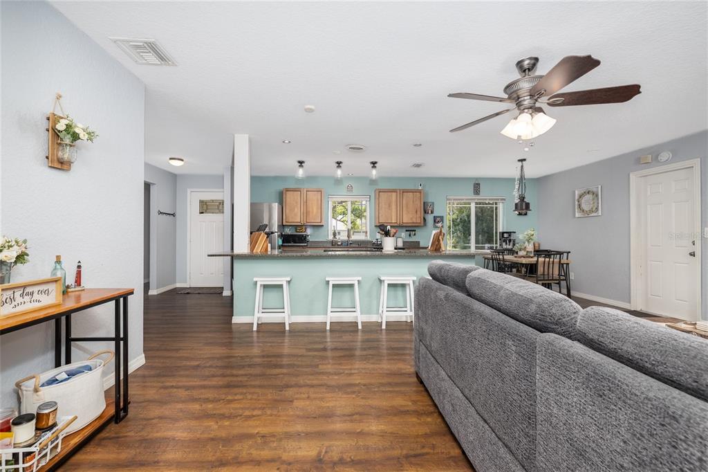1709 Umbrella Tree Drive Edgewater, FL 32132 - Photo 12 of 37 a living room with stainless steel appliances furniture and a kitchen view