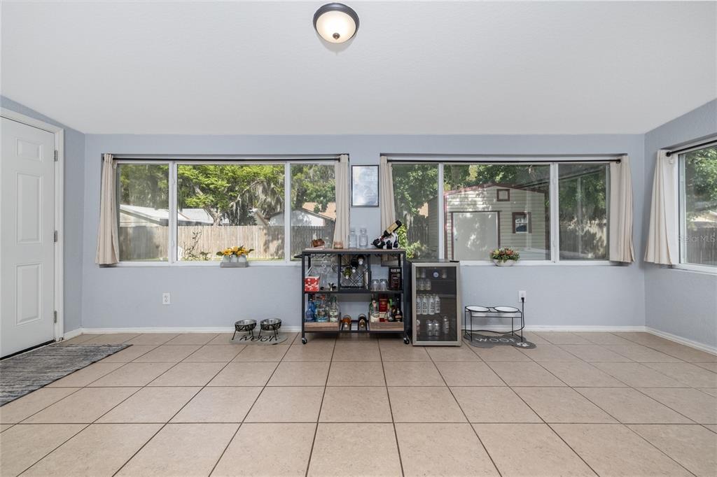 1709 Umbrella Tree Drive Edgewater, FL 32132 - Photo 14 of 37 a room with lots of furniture and a large window