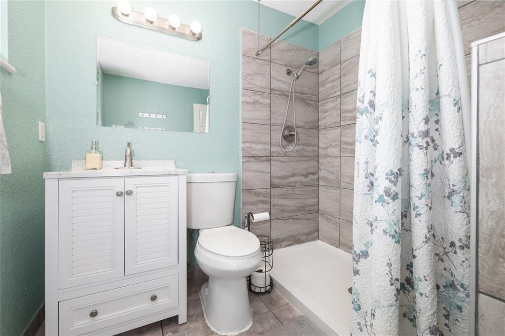 1709 Umbrella Tree Drive Edgewater, FL 32132 - Photo 19 of 37 a bathroom with a sink toilet and shower